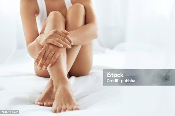 Woman Body Care Close Up Of Long Legs With Soft Skin And Hands Stock Photo - Download Image Now