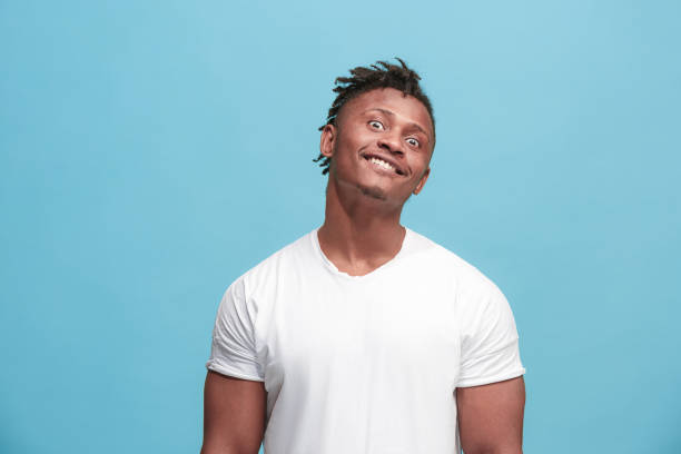istock The squint eyed afro-american man with weird expression isolated on blue 931733490