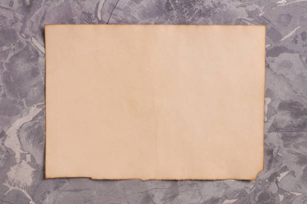 istock One old blank rectangle burnt sheet of paper on gray old broken cement 931734042