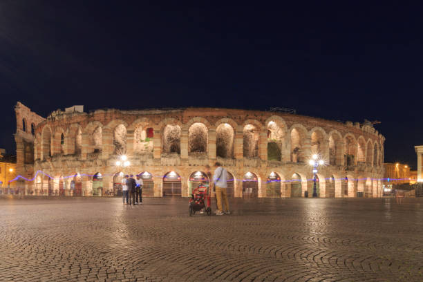 Verona Arena, Italy in a night in springtime Outside view of Verona Arena from Piazza Bra, an ancient roman amphitheatre (Arena di Verona) verona opera stock pictures, royalty-free photos & images