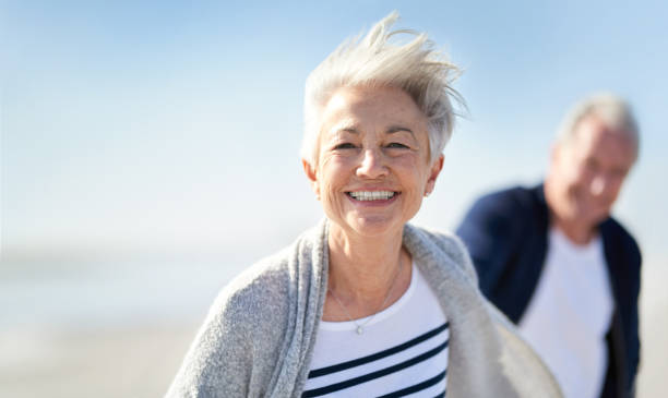 You’re never too old to be young Portrait of a happy senior couple having fun at the beach young at heart stock pictures, royalty-free photos & images