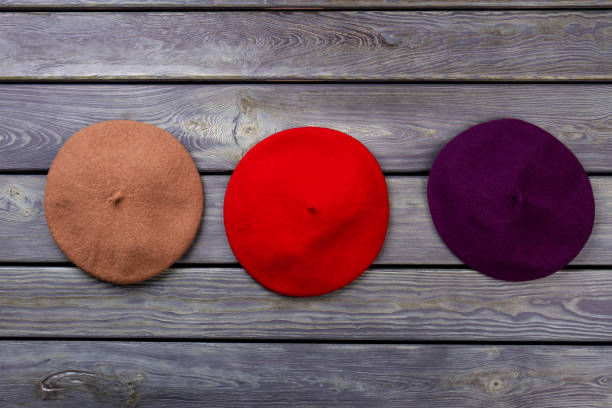 istock Berete hats on wooden background. 931737572
