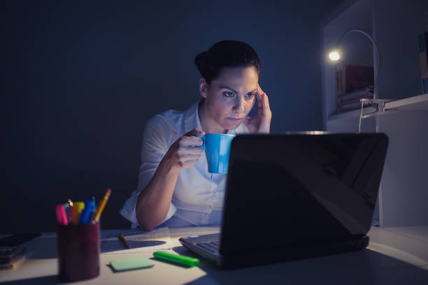 istock Businesswoman using laptop working overtime late at night 931738050