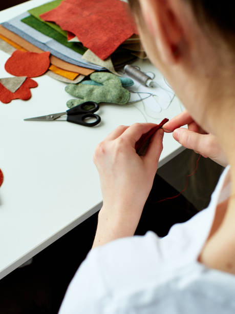istock Step-by-step process of manual manufacturing baby crib mobile. Sewing a seam on a toy. 931748276