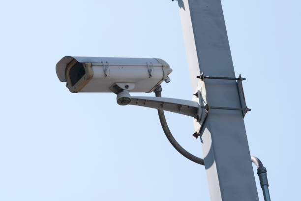 istock Outdoor CCTV Camera Operating for security in garden , on blue sky background 931749418