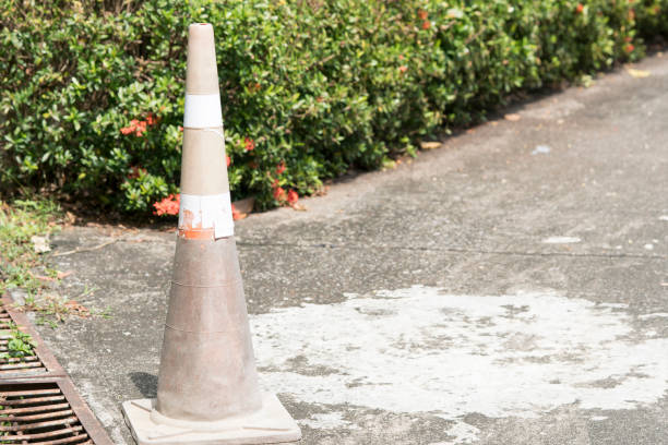 istock Orange Old traffic cones lying on the street 931749772