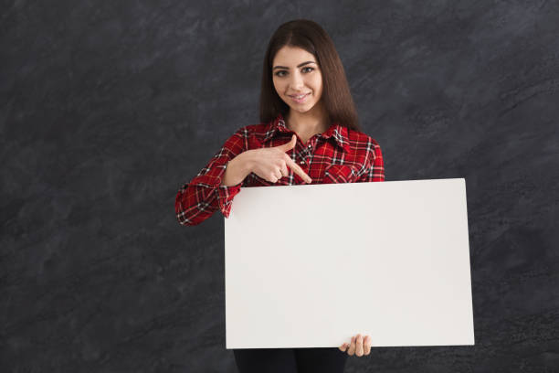 istock Young woman with blank white paper 931750838