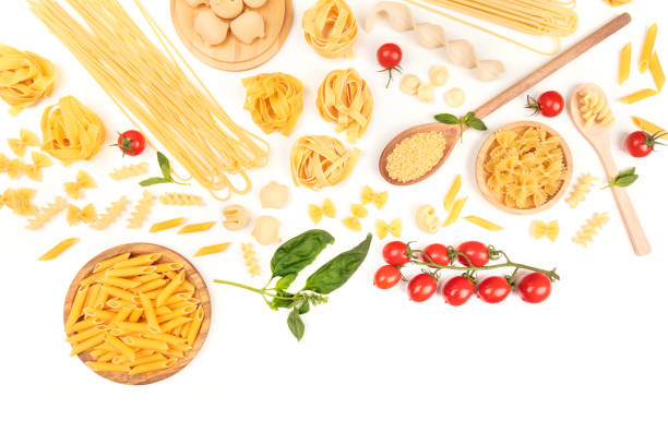 Overhead photo of different types of pasta on white with copy space