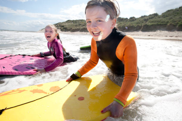 istock Girls Bodyboarding in the Sea 931753676