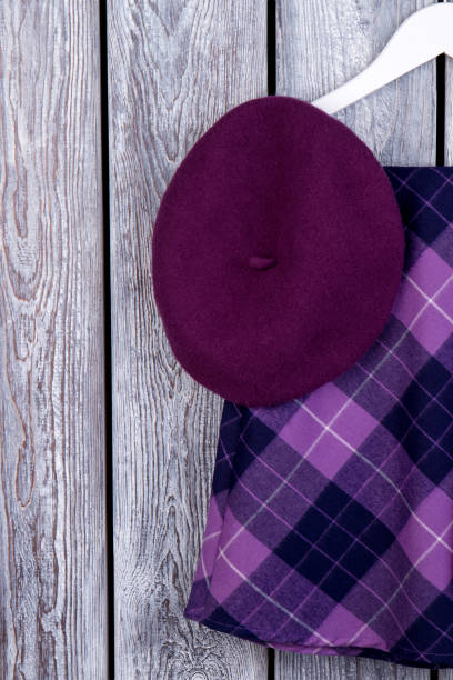 istock Purple beret hat and checkered skirt. 931755744