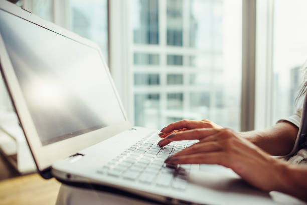 istock Woman using laptop sitting in modern office close up 931755958