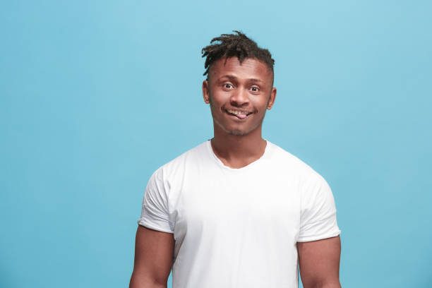 istock The squint eyed afro-american man with weird expression isolated on pink 931757502