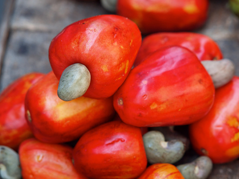 Vibrant red cashew nut with fruit (Anacardium occidentale) at the Street market in Colombia - shallow depth of field shot