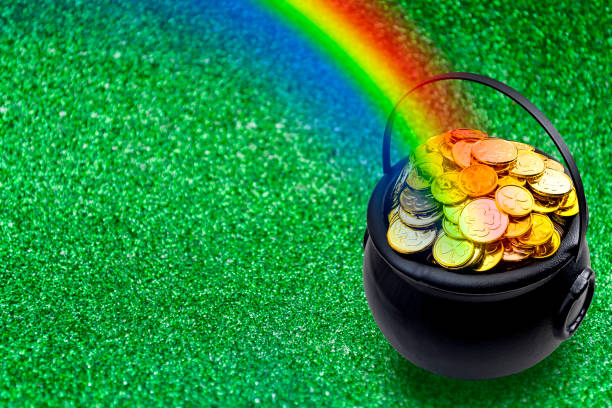 Saint Patrick's Day Saint Patrick's Day and Leprechaun's pot of gold coins concept with a rainbow indicating where the leprechaun hid treasure on green with copy space. St Patrick is the patron saint of Ireland cauldron photos stock pictures, royalty-free photos & images