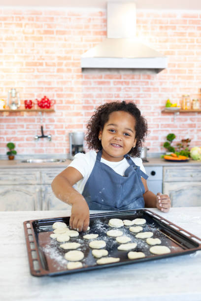istock Little girl preparing homemade biscuits 931764838