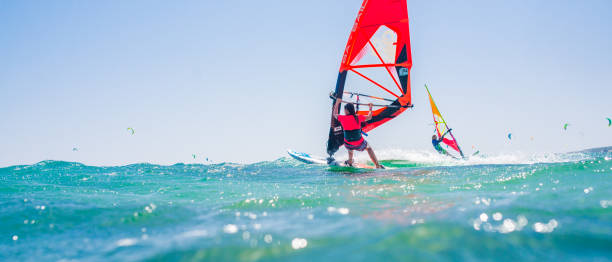 People doing kitesurfing and windsurfing Group of people doing kitesurfing and windsurfing on sea. kite sailing stock pictures, royalty-free photos & images