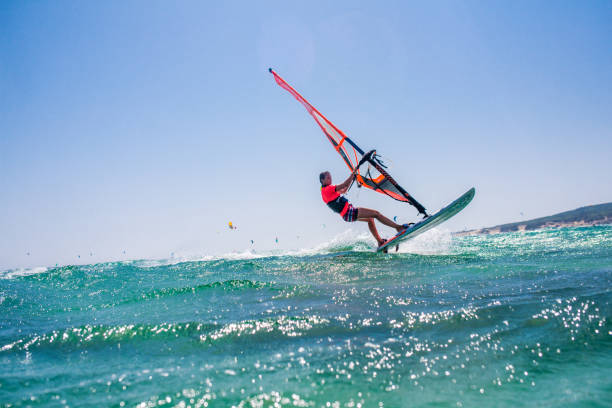 ludzie uprawiający kitesurfing i windsurfing - windsurfing zdjęcia i obrazy z banku zdjęć