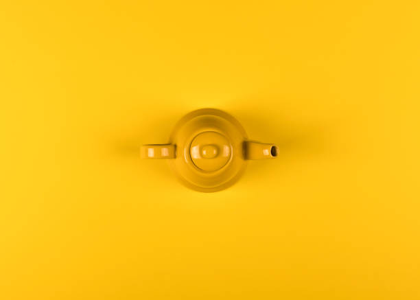 istock yellow ceramic teapot on a yellow background 931775616