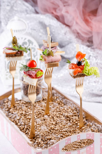 istock Original canapes on forks. Exquisite still life. 931776236