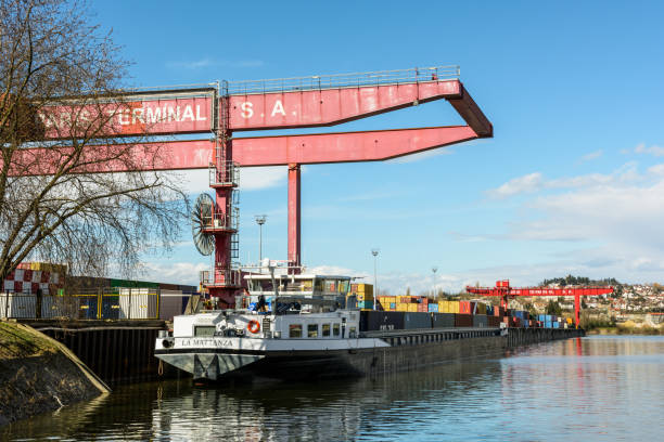 Gennevilliers, France - March 11, 2018: A barge loaded with containers is docked in the intermodal terminal, run by the society Paris Terminal, in the Gennevilliers port, first french river port.