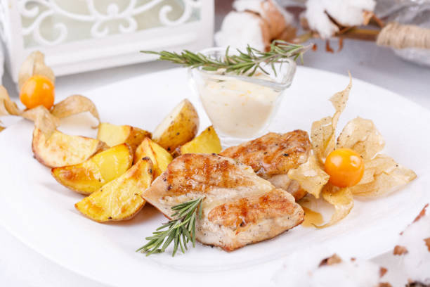 istock Delicate chicken fillet with a garnish of young potatoes. 931776738