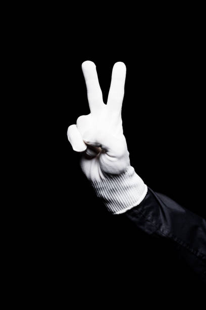 istock cropped image of mime showing peace sign isolated on black 931776818