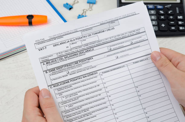 istock Man holding polish tax form VAT-7 931776912