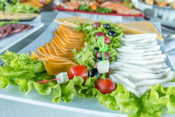 istock Salad with sausage, greens and other on table with white table. Catering concept. 931777424