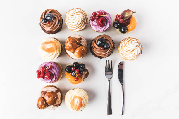istock flat lay with arranged various sweet cupcakes and cutlery isolated on white 931777896