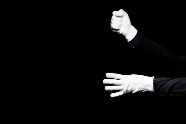 istock cropped image of mime pretending climbing a rope isolated on black 931777982