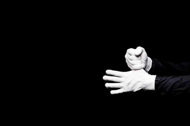 istock cropped image of mime hiding thumb isolated on black 931778064