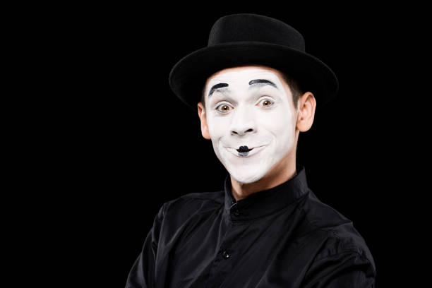 istock happy mime looking at camera isolated on black 931778190