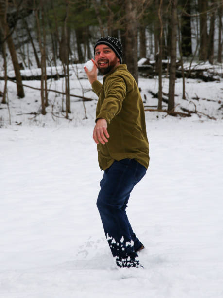 istock Bearded Man Having Snowball Fight Throwing Snowball 931778360