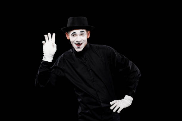 istock happy mime waving hand isolated on black 931778740