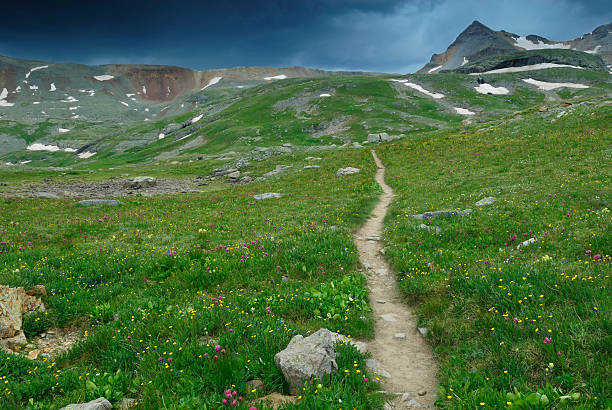 Storm clouds over a mountain meadow stock photo