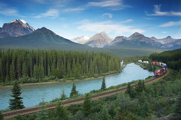 Railway with train in Banff National Park, Canadian Rockies  freight train stock pictures, royalty-free photos & images
