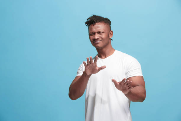 istock Young man with disgusted expression repulsing something, isolated on the blue 931786212