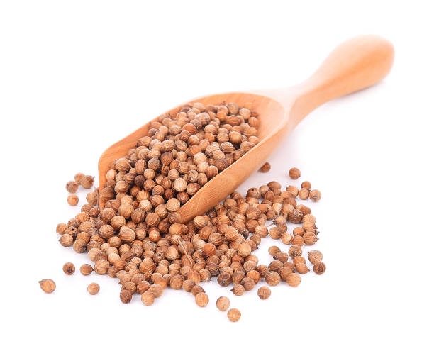 istock Coriander seeds in wood spoon on white background 931786276