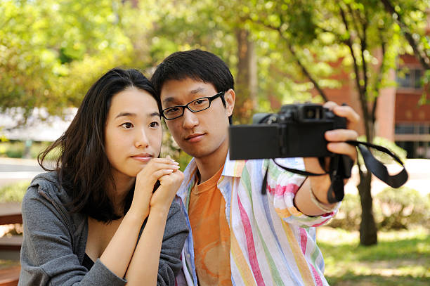 istock Young campus couple taking picture of themselves 93178634