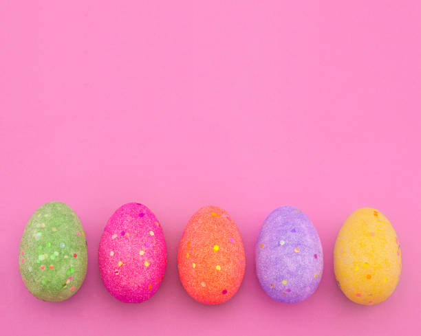 istock Decorated colorful Easter eggs on pink paper background with space for text. Trendy minimal pop art style and colors. 931789972