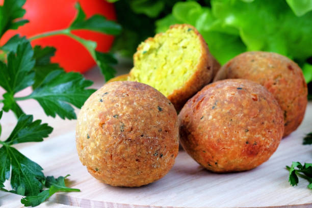 istock Vegetarian Falafel balls on a light cutting board. 931790534