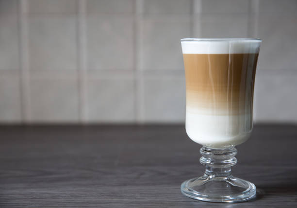 Creamy Macchiato Coffee Glass A creamy and frothy Macchiato or cappuccino coffee in a tall glass and on a clean background Skinny Latte stock pictures, royalty-free photos & images