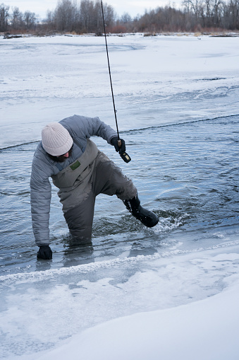 Ice fishing catching trout copy space image