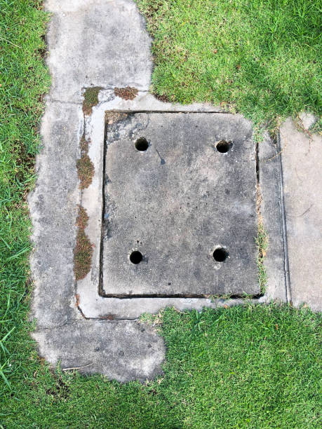 istock Cement sewer cover on the lawn 931795064