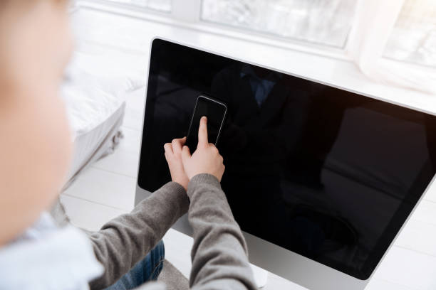 istock Pleasant cute boy pressing the finger to the screen 931800166