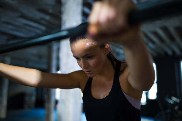 istock Determined athlete gripping barbell in gym 931801946