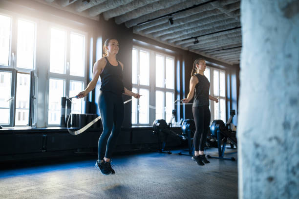 istock Sporty women doing workout with jump ropes in gym 931804392