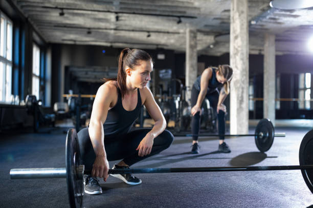istock Exhausted women relaxing after workout at gym 931805664