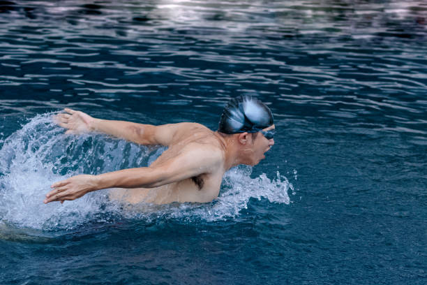istock dynamic and swimmer in cap breathing performing the butterfly stroke 931805686