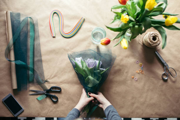 Concept photo of human hands creating tulip bouquet
